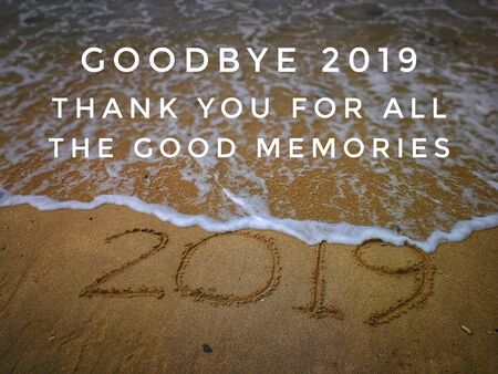 Text label with background of 2019 written on sandy beachの写真素材