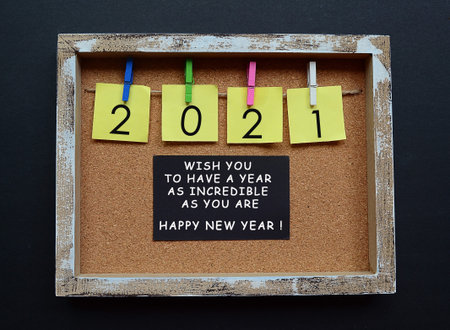 New year quote for 2021 with yellow paper and clothespin hanging on a string with wooden frame...