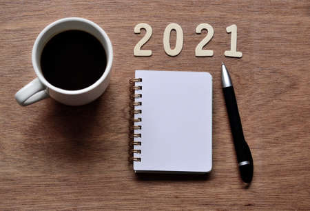 New Year 2021 concept with background of cup of coffee and note pad. Happy New Year 2021の写真素材