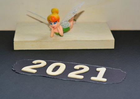Miniature Fairy Starring At Year 2021. Blurred Background. New Year 2021 Concept