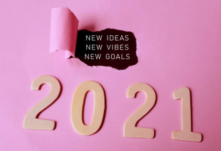New ideas, new vibes, new goals text on torn paper with Year 2021 backgroundの写真素材