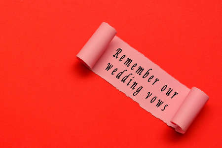 Remember our wedding vows label on torn paper with red paper background. Wedding And Valentine's Day Conceptの写真素材