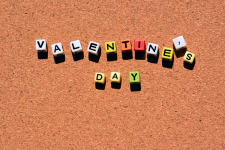 VALENTINE'S DAY word of colorful cube alphabet on wooden background. Valentine's Day Conceptの写真素材