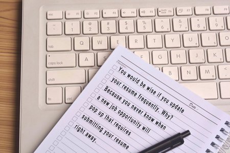Text on notepad with laptop background wooden table. Job opportunity concept