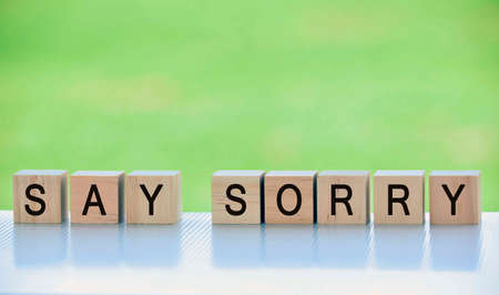 Text on wooden cube block with blurred green backgroundの写真素材