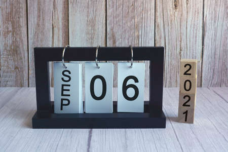 Text and numbers on wooden block cube and paper stand frame - Labor day conceptの写真素材