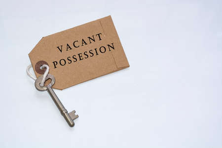 Text on a tag with key on white background - Vacant possessionの写真素材