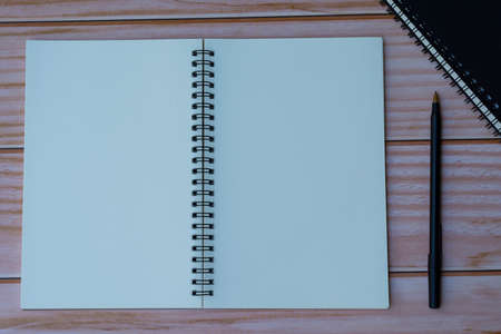 Notepad with pen on wooden background. For text useの写真素材