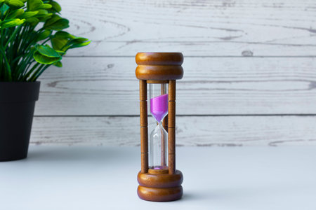 Hourglass as time passing concept for business deadline and running out of time