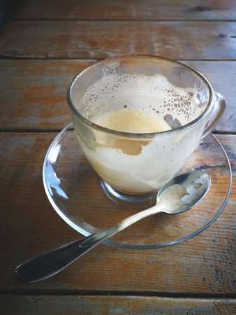 Empty coffee cup with cookies on wooden table in cafeの写真素材