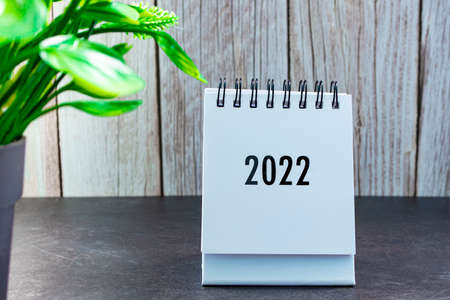 2022 calendar with potted plant on a desk. New Year Conceptの写真素材