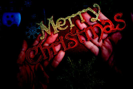 Hand holding Christmas decoration with background of ornaments decor.の写真素材