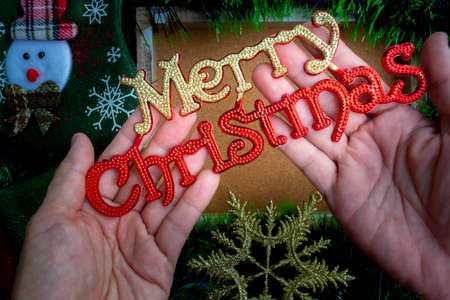 Hand holding Christmas decoration with background of ornaments decor.の写真素材