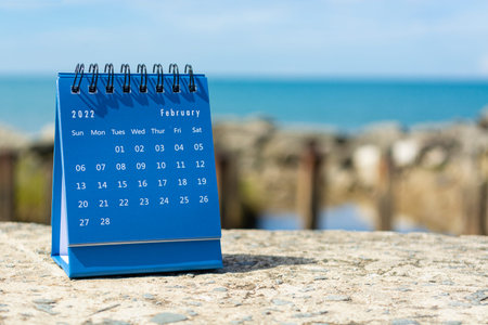Blue February 2022 calendar on blurred background of blue ocean. 2022 New Year Conceptの写真素材