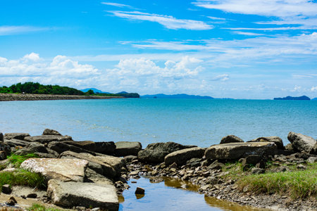 Blue sea under blue skies with white clouds at Tanjung Aru Beach, Kota Kinabalu, Sabah, Malaysia.