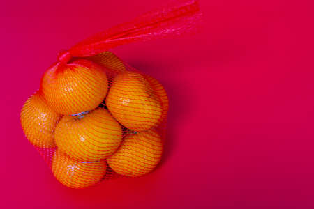 Concept image of the chinese new year. Mandarin orange on red backgroundの写真素材