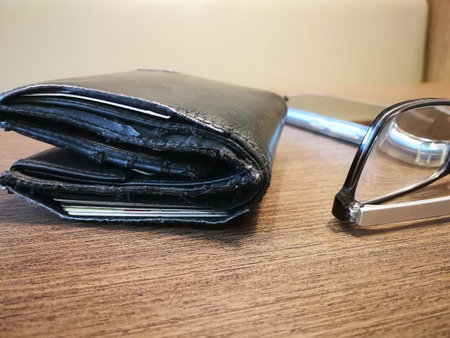 Blurred background of old wallet on the wooden deskの写真素材