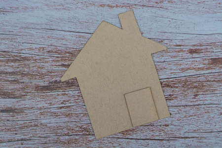 Brown paper house model on wooden table. Concept for real estate property tax. Renting and buying concept.の写真素材