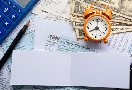 Tax forms 1040. U.S Individual Income Tax Return with other stationeries on a desk. Business and tax...