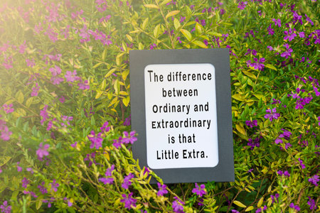 Motivational quote on notepad with flowers and green leave background