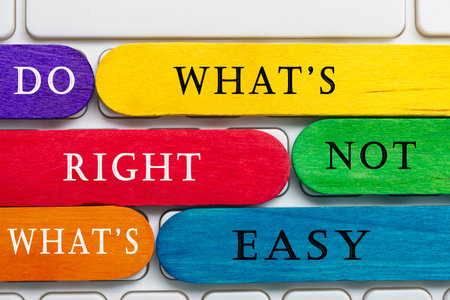 Colorful wooden sticks with word on a white keyboard - Do What's Right Not What's Easy.