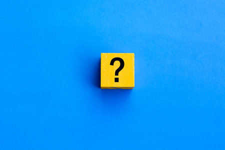 Cube with question mark on blue background.の写真素材