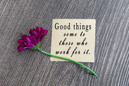 Motivational quote on torn brown paper - Good things come to those who work for it.