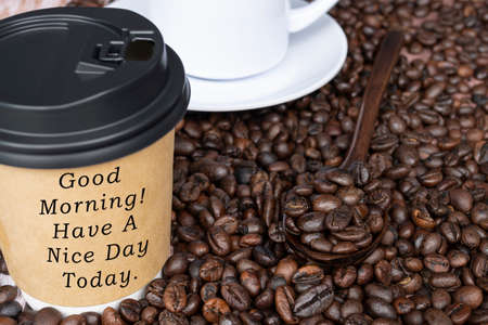 Motivational quote on disposable coffee cup on coffee beans background - Good morning, have a nice day today.の写真素材