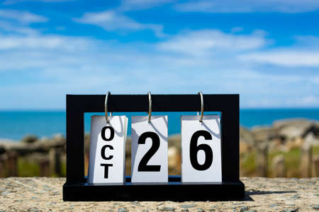 Oct 26 calendar date text on wooden frame with blurred background of ocean. Calendar date concept.の写真素材