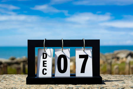Dec 07 calendar date text on wooden frame with blurred background of ocean. Calendar date concept.の写真素材