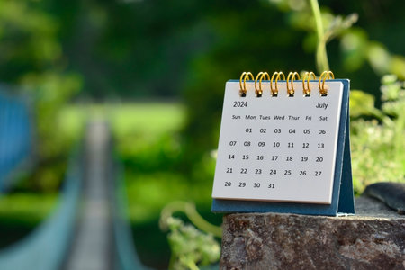 July 2024 calendar with green blurred background of hanging bridge. New year concept.の写真素材