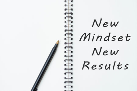 Motivational and inspirational quote on notepad - New mindset new resultsの写真素材