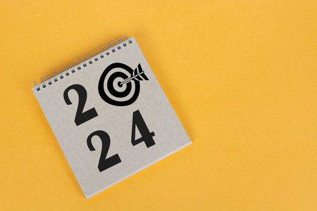 2024 number on brown notepad with copy space. Business goals and success concepts.の写真素材