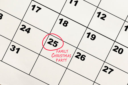 Red circle mark on the calendar at 25 for reminder of family christmas party. New year celebration concept.の写真素材