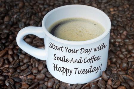 Motivational quote on a cup of coffee with beans background - Start your day with smile and coffee. Happy tuesday.の写真素材