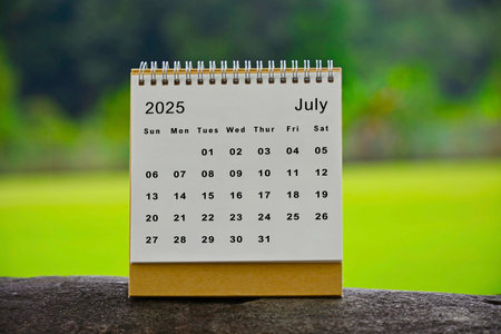 July 2025 white calendar with green blurred background - New year conceptの写真素材