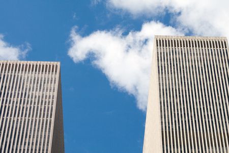 Modern skyscrapers against a bright blue skyの写真素材