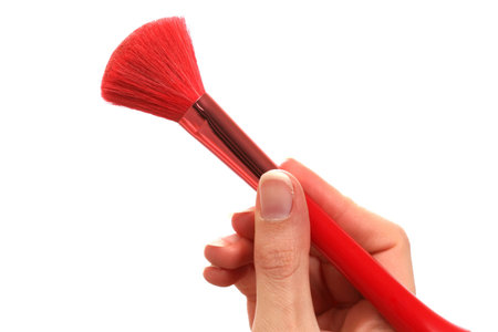 Hand holding a makeup brush
