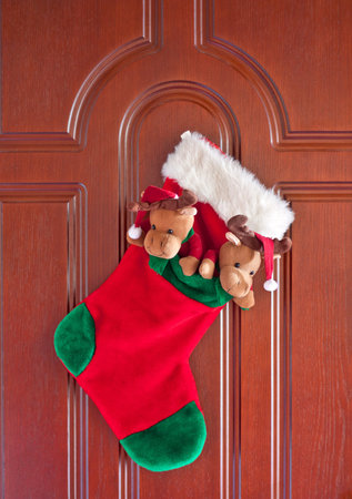 Red christmas sock for presents on the front door