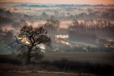 Morning glow across the fields and lakesの写真素材