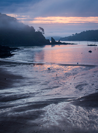 Sun rise on a misty morning looking through the inletの写真素材