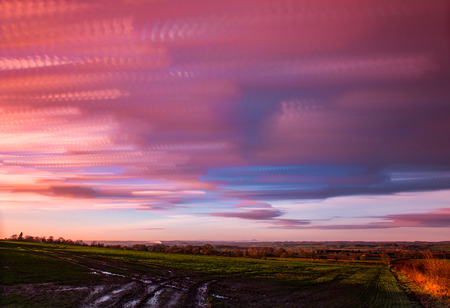 timelapse movement of clouds at sunset with  far reaching scenic landscapeの写真素材