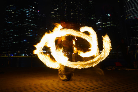 SINGAPORE - MAR 9  Fire Dancers street performance at Marina Bay on Mar 9, 2014 in Singapore のeditorial素材