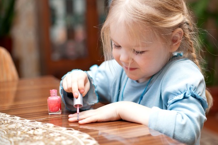 The little girl paints nailsの写真素材