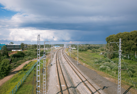  railway line stretching into the horizon on a background cloudy skyの写真素材