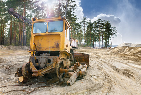 Ðbandoned broken excavator equipment in a sandpit
