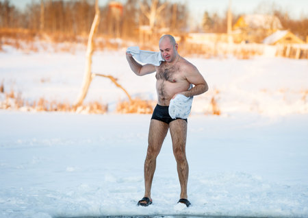man wipes towel after swimming in the freezingの写真素材