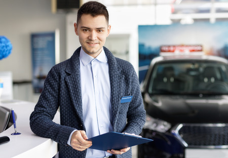 salesman about new car in dealershipの写真素材
