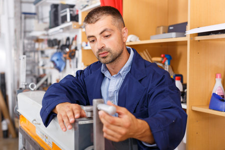 worker adjusts equipment a printer studio
