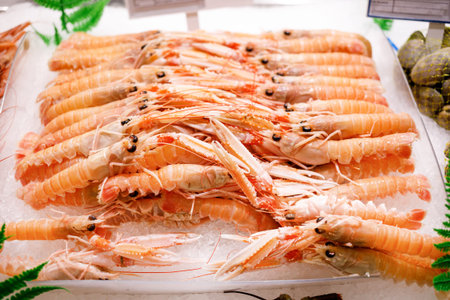 Fresh lobsters on ice. Colored artropods lookz appetizing.Dinner with delicious meat from the sea.